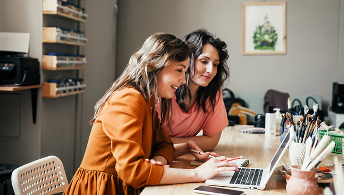 two women working on computer