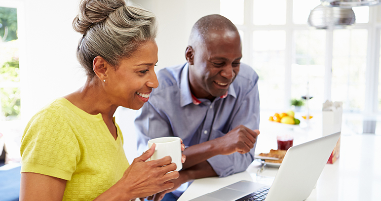 man and woman looking at laptop